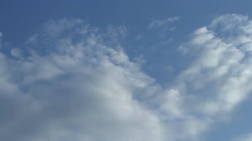 Puffy Cumulus Clouds Swirl at Sunset