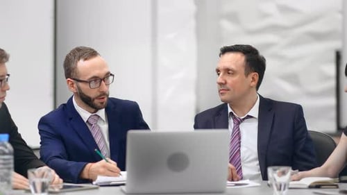 Team Having a Serious Business Meeting at Table