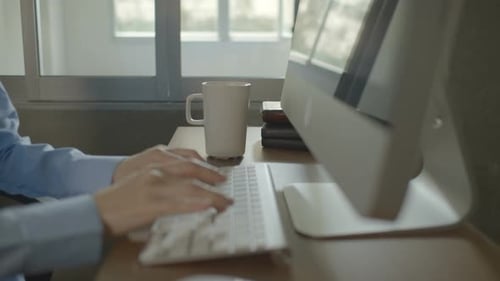 Close Up of Hands Typing at Computer in Office