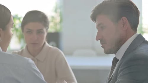 Close up of Serious Male and Female Business People Talking
