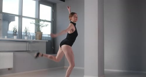 Pretty Ballet Dancer Does Big Jump in Dance Studio in Slow Motion, Ballet Rehearsal, Ballerina Does