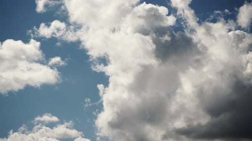 White Clouds Floating Across Blue Sky in Time Lapse