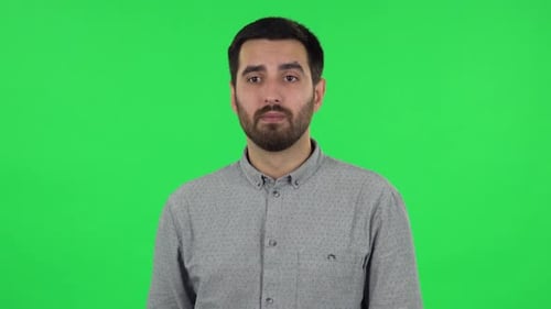 Portrait of Brunette Guy Is Waiting, Then Celebrating His Victory Triumph. Green Screen