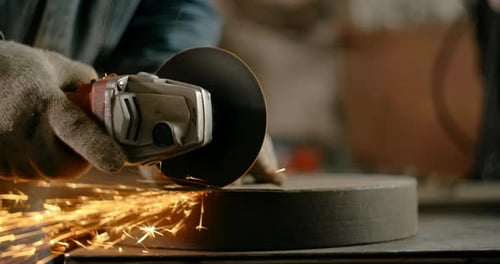 Locksmith Cuts Sheet Metal with a Grinder with a Lot of Sparks in Slow Motion Metalwork at Workshop