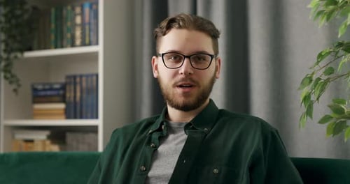 Smiling Man Talking on Couch