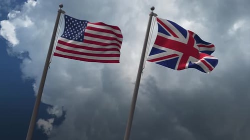 USA and UK Flags Waving on Poles Against Cloudy Sky