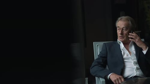 Elderly Businessman Talking on a Cell Phone