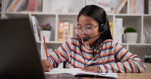 Student Studies At Home With Laptop and Headset