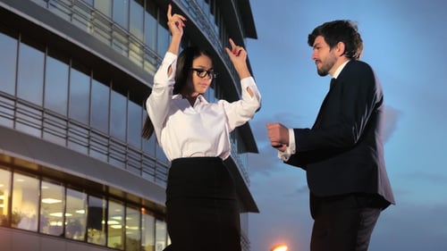 Business People Dancing outside Office Building at Night
