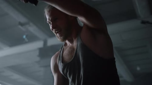 Man Exercising with Workout Ropes in Gym
