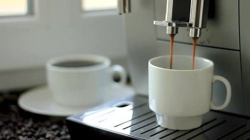 Espresso Pouring from Modern Machine into White Mug