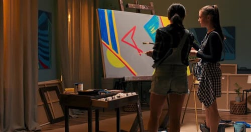 The Artist's Friends Spend Time Together in Painting Studio Create a Picture on Canvas the