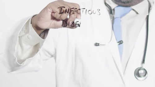 Doctor Writing Infectious Diseases on Glass Surface