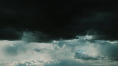 Dark Rain Clouds In Cloudy Blue Sky. Transition To Natural Black Stormy Sky