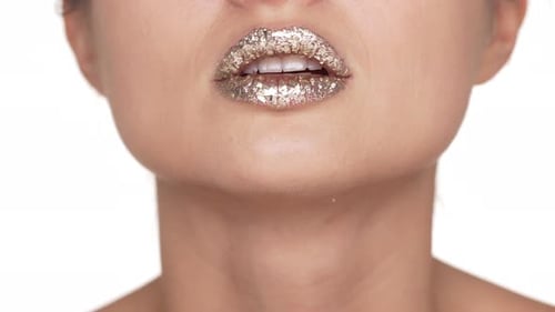 Woman's Lips Covered with Silver Glitter Makeup