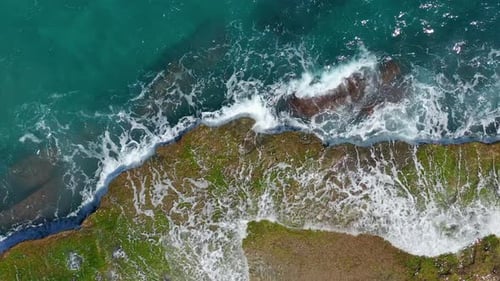 Aerial View. Waves Crashing on Rocks.