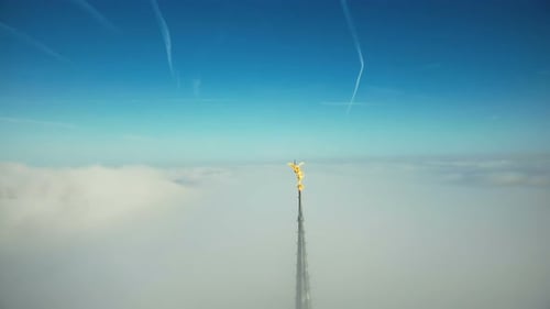 Drone Flying Away From Epic Golden Angel Statue on Top of Mont Saint Michel Castle Steeple