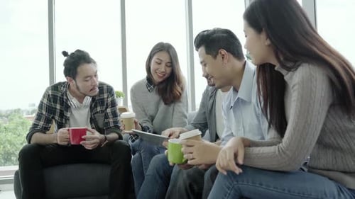 Four Young Adults Collaborate in Modern Office