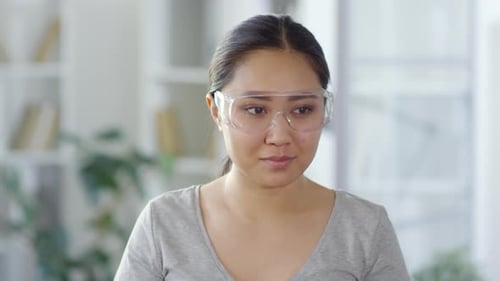 Woman Puts on Safety Glasses and Uses Tracker