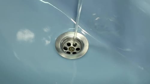 Water Draining in a Blue Sink