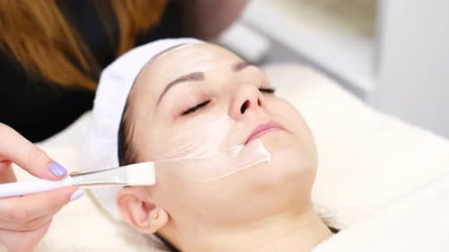 Woman Receiving Facial Mask at Spa