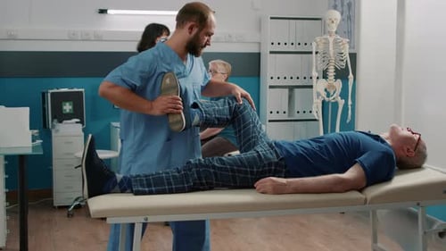 Physical Therapist Assisting Patient with Leg Exercise