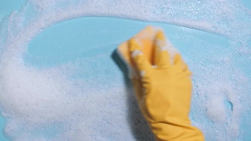 Cleaning Surface With Sponge and Soapy Bubbles