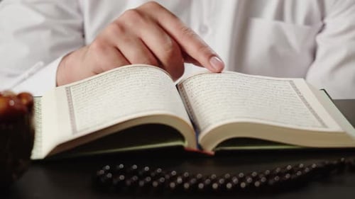 Man Praying with Rosary Reading Koran Closeup Islamic Religion