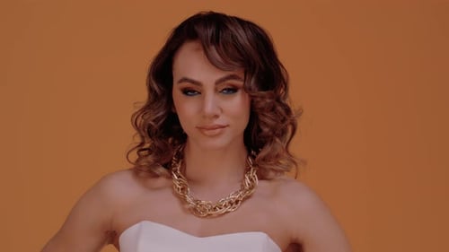 Glamorous Woman with Bold Makeup Posing in Studio