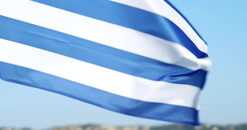 Waving Blue and White Striped Flag on Beach