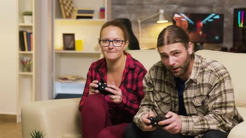 Couple Playing Video Games on the Couch at Home
