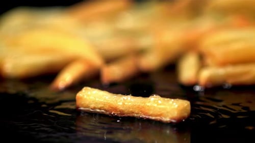 Super Slow Motion French Fries are Fried in Oil in a Frying Pan