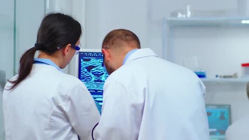 Doctors Analyze Medical Scan in Research Lab