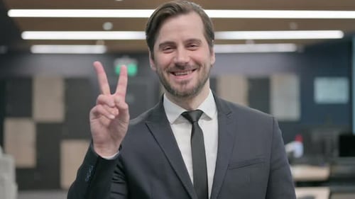 Portrait of Businessman Showing Victory Sign with Finger