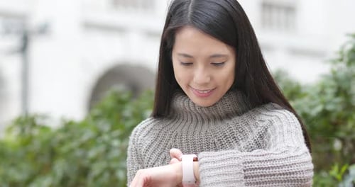 Woman Using Smart Watch Device in City