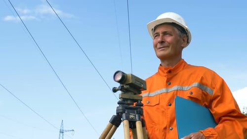 Experienced Survey Specialist Stands Near Dumpy Level