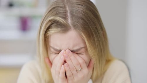 Young Woman Crying with Face in Hands