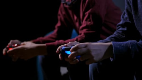 Closeup Hands of Teen Boys Playing Video Game