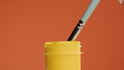 Yellow Paint Isolated on Orange Background