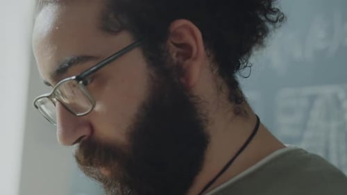 Bearded Student Talking during University Class