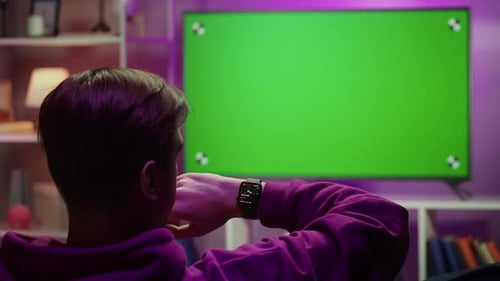 Man Using Smartwatch Watching Television with Chroma Key Closeup