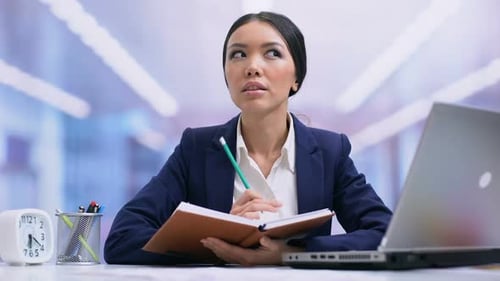 Female Taking Notes in Workplace Office Close Up