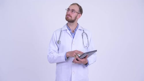 Doctor Using Tablet and Thinking in Studio Setting