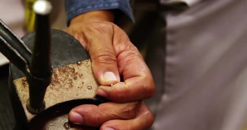 Skilled Hands Repairing Shoe Heel with Hammer