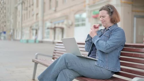 Woman Working on Laptop on Park Bench