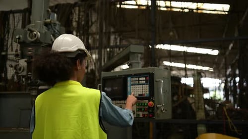 Female chief mechanical engineer working in a mechanical factory