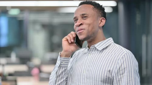 Young Adult Smiling, Talking on Mobile Phone