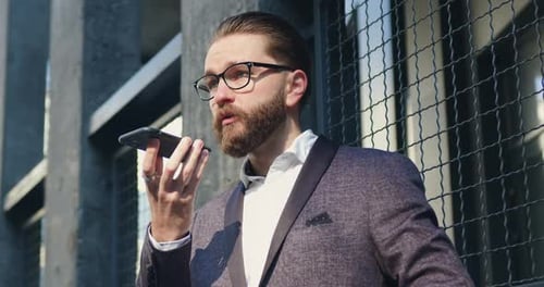 Bearded Man in Sport Coat Using Smartphone Outdoors