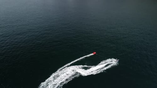 Jet Ski Pulling Tube on Blue Ocean
