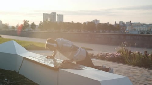 Man Exercising at Sunrise in the City Park